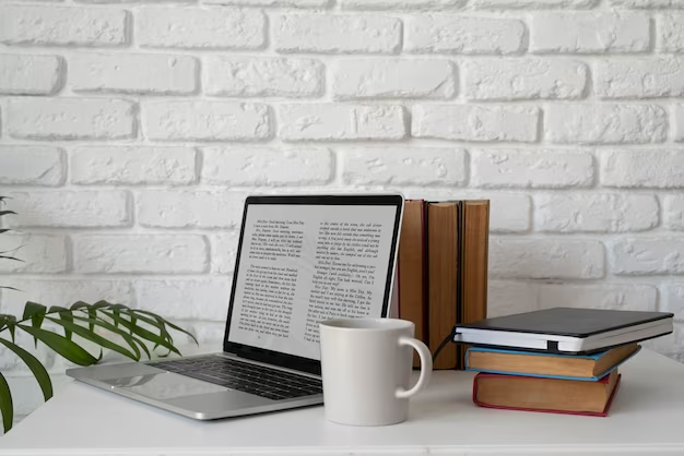 Laptop, mug, and books