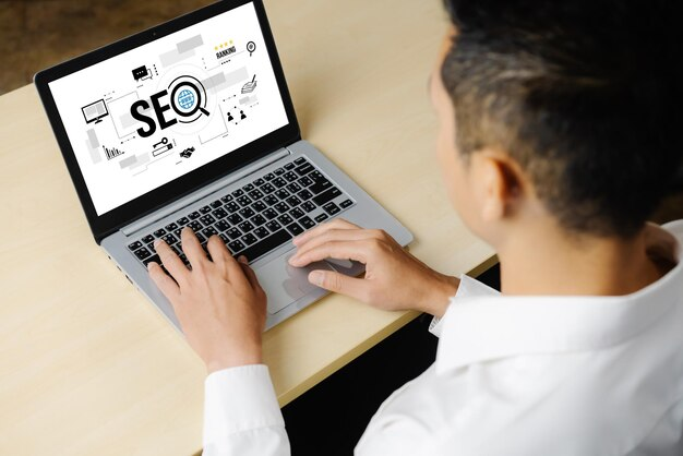 Man with a laptop displaying SEO on screen